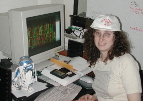 Ellen with Nerd Pride hat in front of computer
